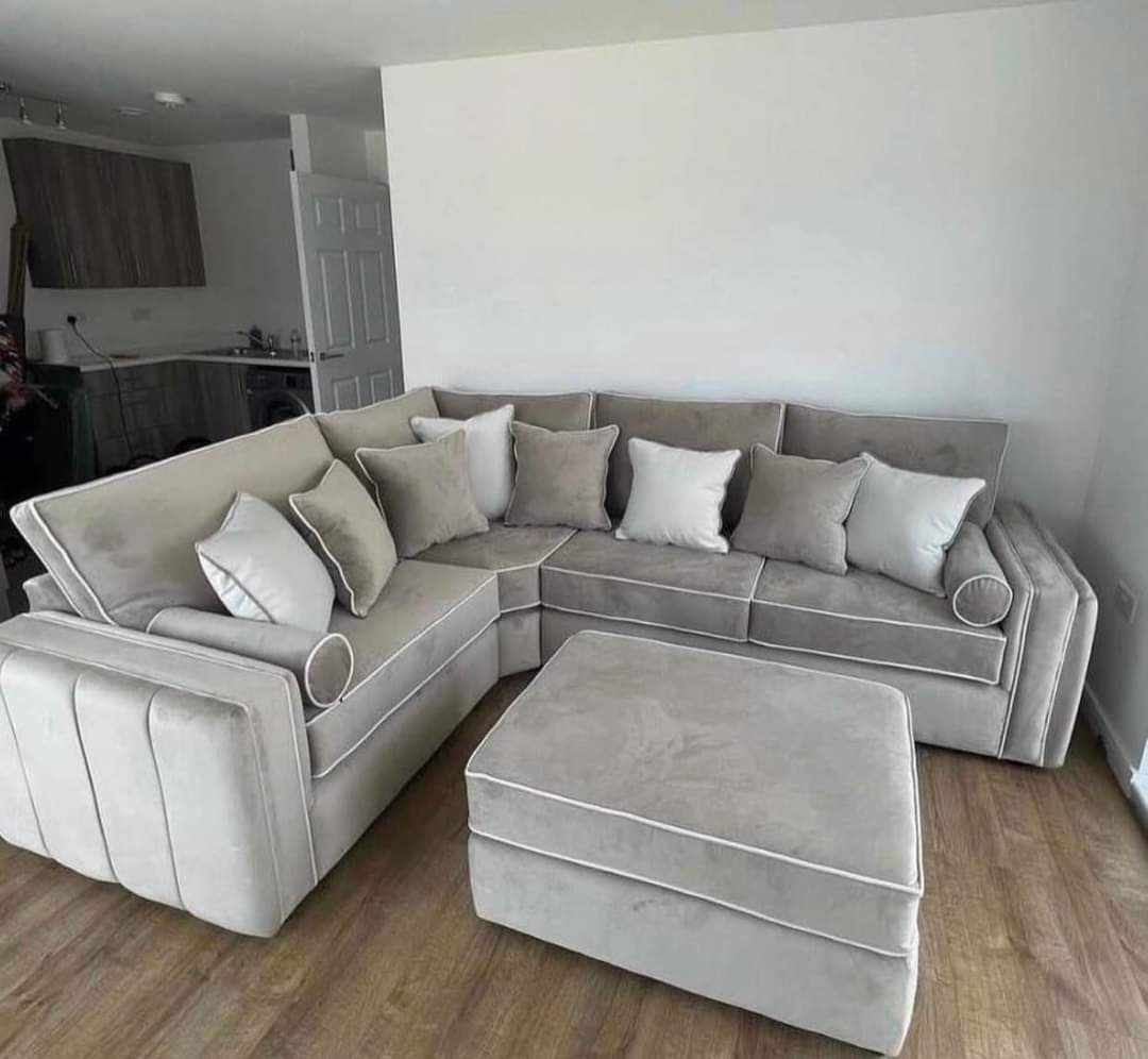 Furnish UK plush velvet corner sofa in light gray with matching ottoman and multiple cushions