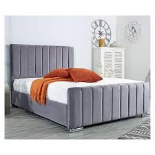 Furnish UK black panel headboard bed with vertical stitching and soft gray upholstery in modern bedroom