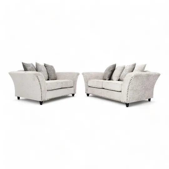 Comfortable L shaped sofa UK in light grey fabric with plush cushions and curved armrests