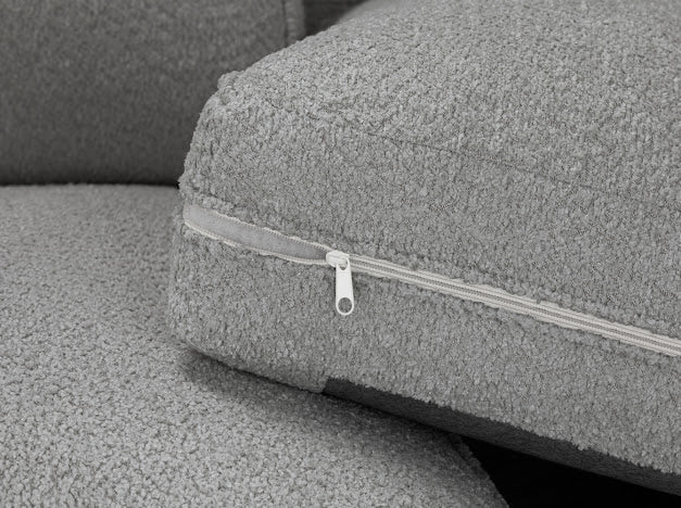 Close-up of gray fabric texture and zipper on comfortable U shaped lounge sofa by Furnish UK