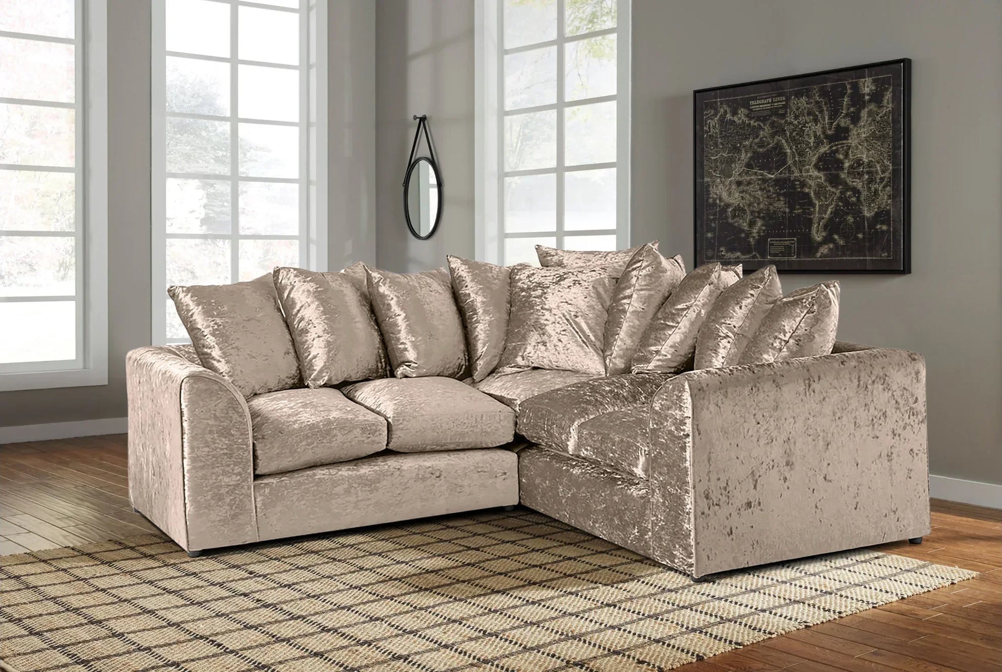 Spacious beige crush velvet corner sofa with multiple cushions in a bright modern living room