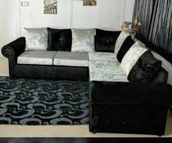 Customer photo of Furnish UK crush velvet corner sofa in black and silver with patterned cushions and a decorative rug