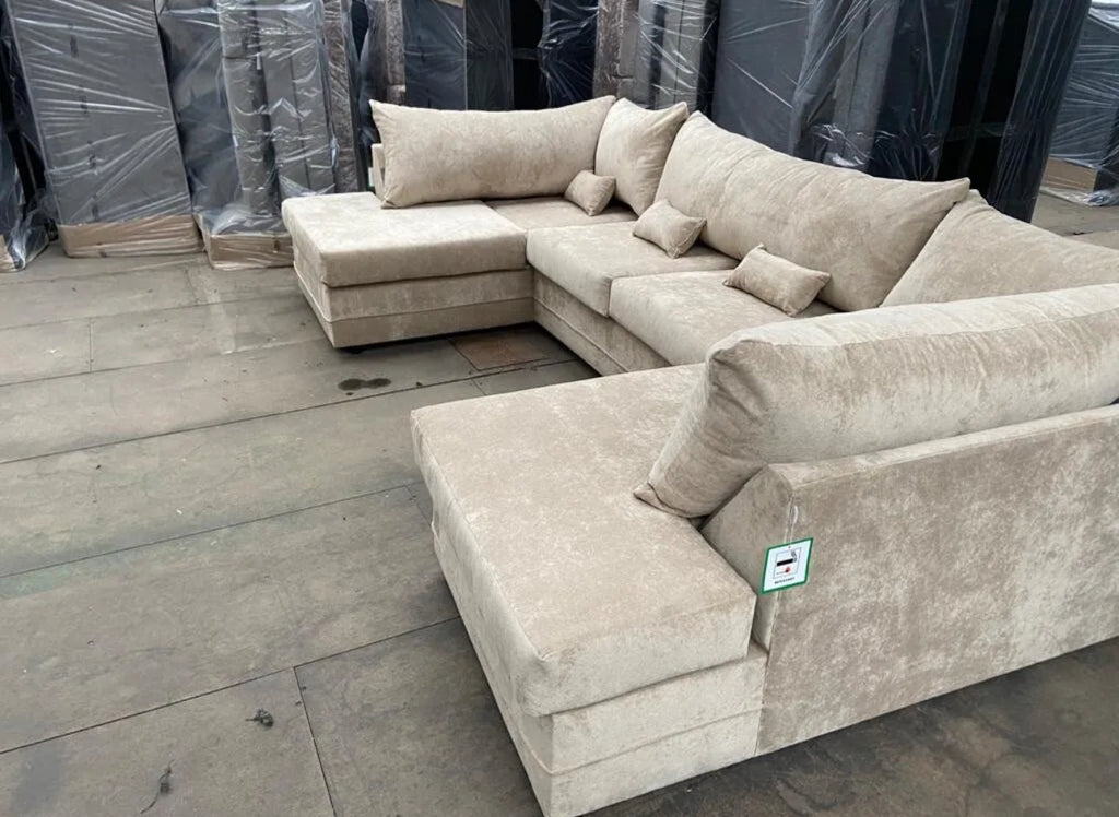 Beige large U shaped sofa with chaise from Furnish UK with multiple cushions in warehouse