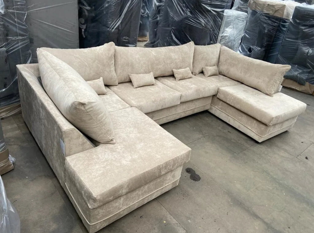Large U shaped sofa with chaise in beige fabric by Furnish UK with plush cushions and spacious seating