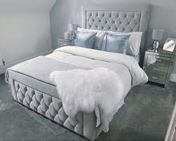 Luxury velvet bed frame in light gray with tufted headboard and footboard in modern bedroom