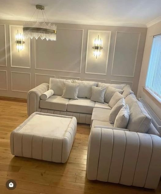 Furnish UK modern L-shaped sofa in beige fabric with matching ottoman in a stylish living room