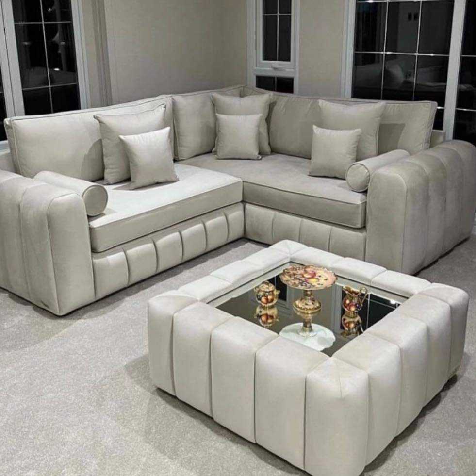 Furnish UK modern L-shaped sofa in light grey with plush cushions and matching ottoman in a living room