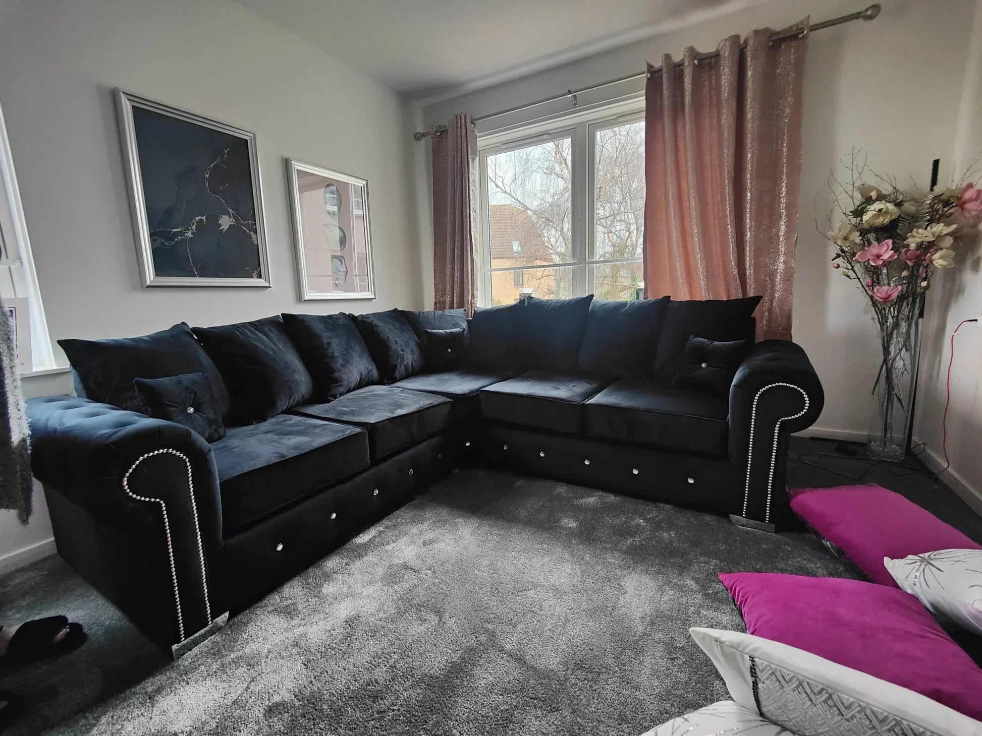 Olympia plush black couch by Furnish UK in a modern living room with decorative pillows and curtains