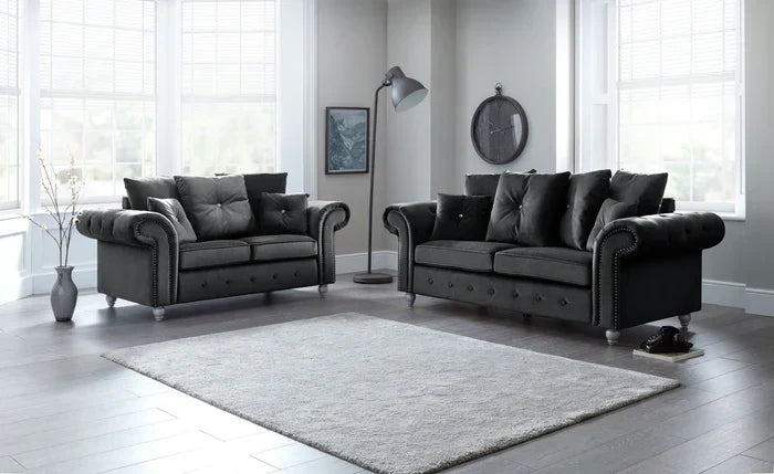 Olympia plush black couch set by Furnish UK featuring a two-seater and three-seater with rolled arms and button tufting