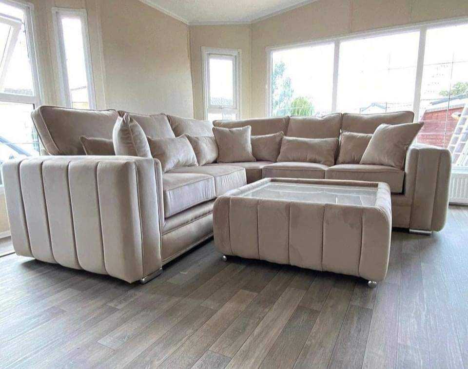 Furnish UK plush velvet corner sofa in light beige with matching ottoman in a bright living room