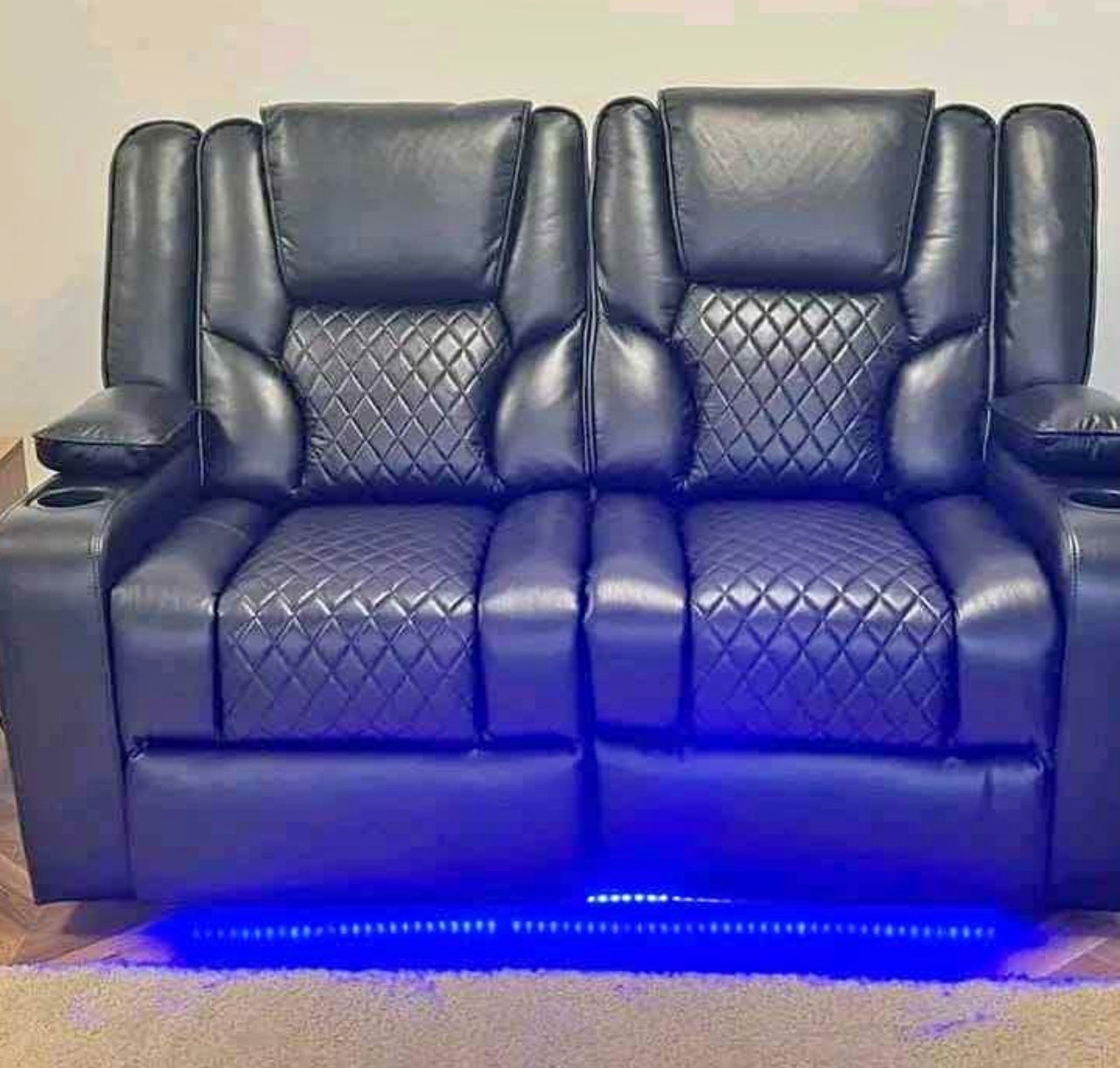 Furnish UK electric leather recliner sofa in black with quilted seats and blue LED lighting