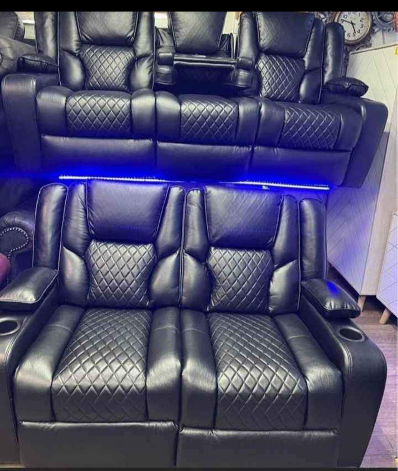 Black electric leather recliner sofa with diamond-stitched cushions and LED lighting