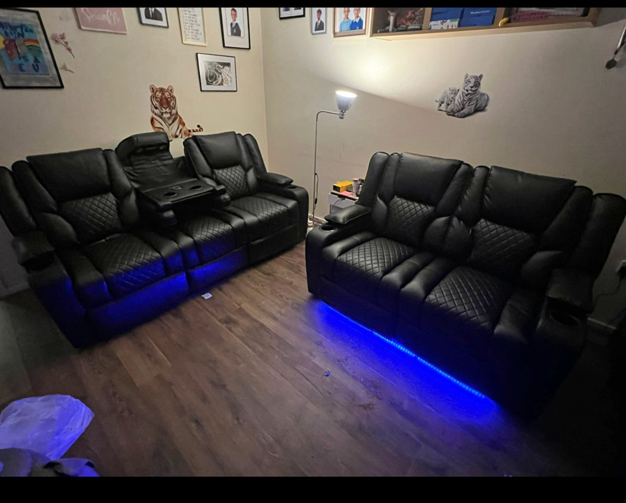 Black electric leather recliner sofa set with blue LED lighting in modern living room