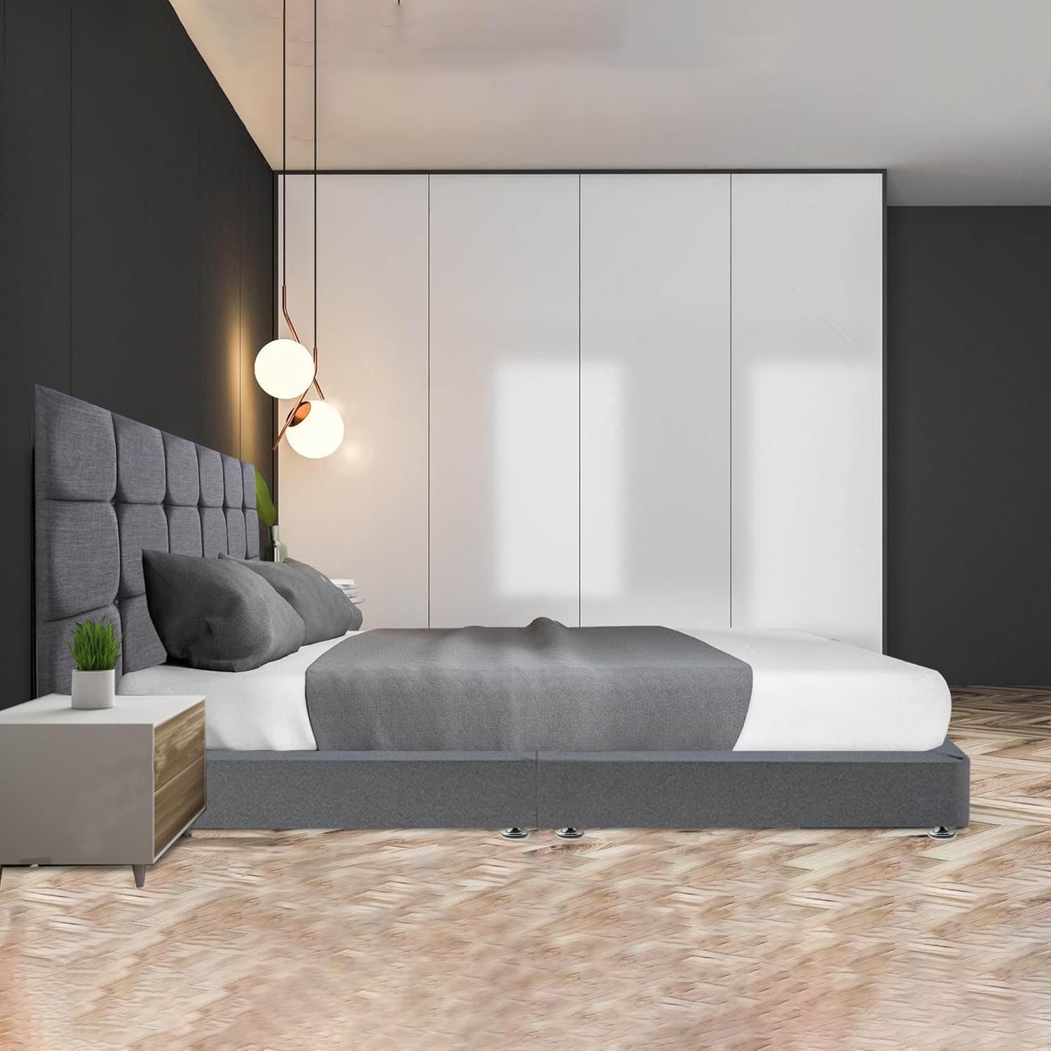 Modern upholstered divan bed in gray with tufted headboard in a stylish bedroom setting