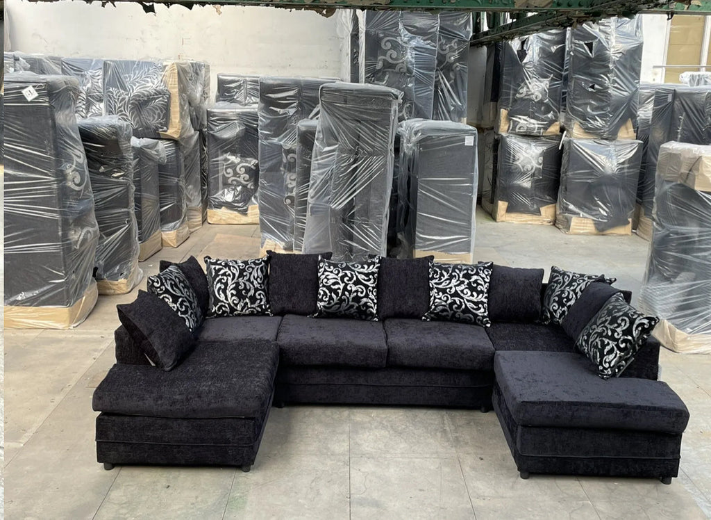 U shape fabric sofa with cushions in dark gray fabric with patterned pillows from Furnish UK in warehouse